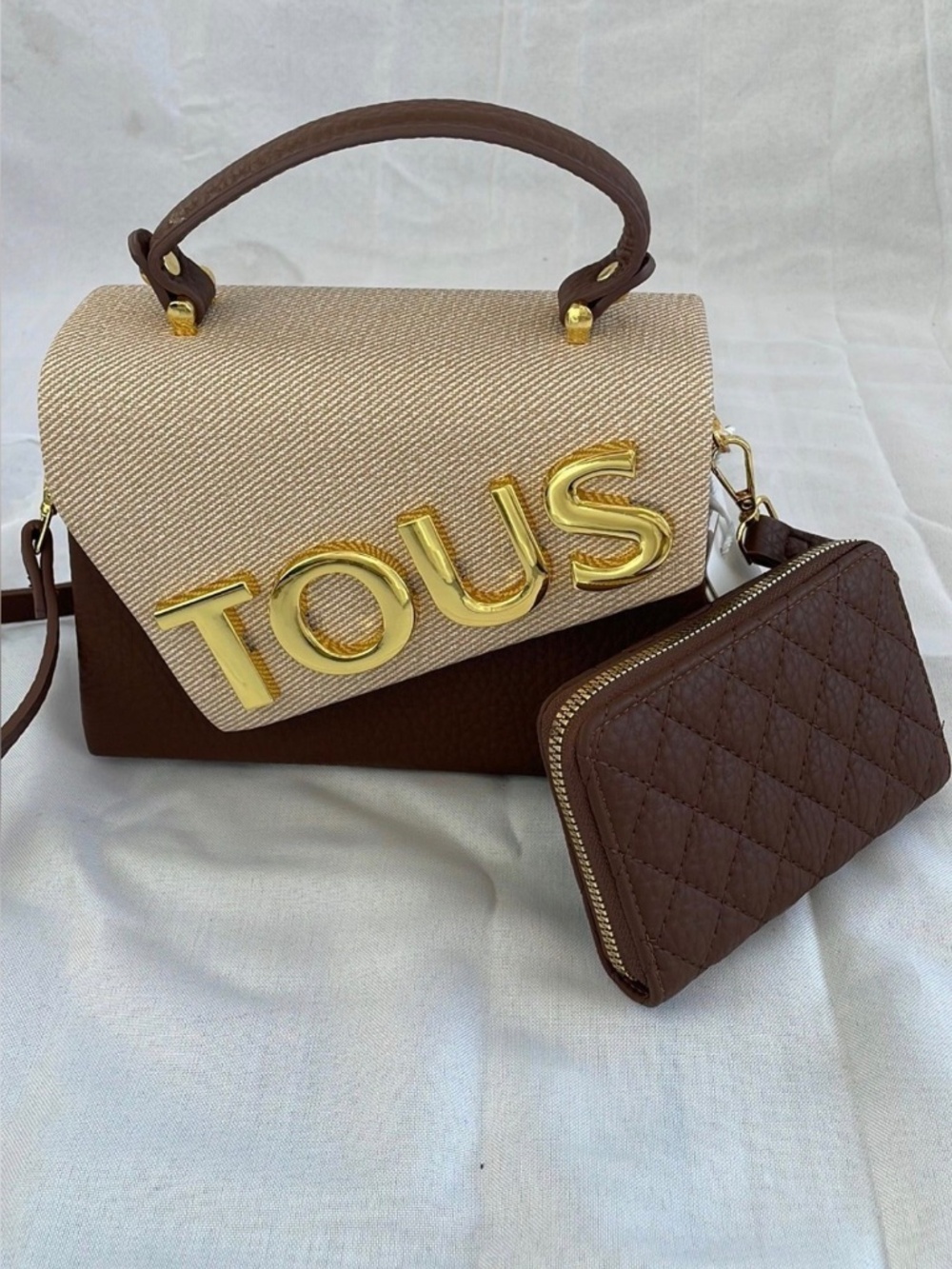 Brown purse with the words Tous on it with a wallet